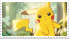 Pikachu in a forest, looking curiously at the camera.