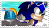 Sonic in a beach chair with sunglasses and a tropical drink.