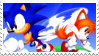 Sonic and Tails flying through a blue sky.